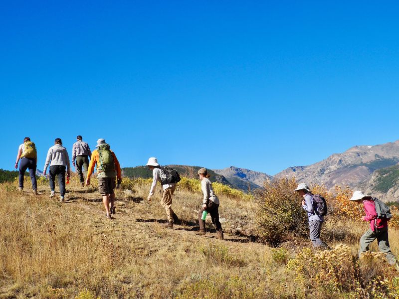 people walking over hill at Rocky Mountain National Park